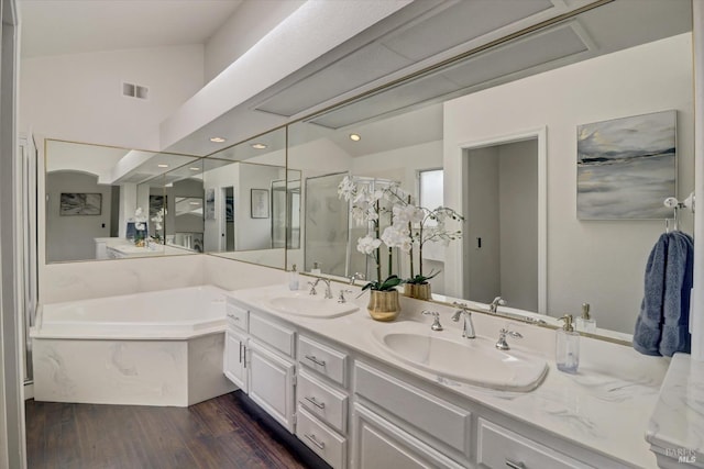 bathroom with hardwood / wood-style floors, vanity, lofted ceiling, and shower with separate bathtub