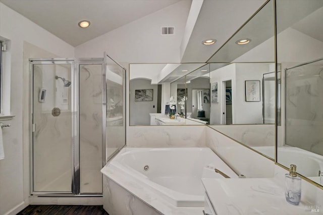 bathroom featuring hardwood / wood-style flooring, plus walk in shower, vanity, and vaulted ceiling