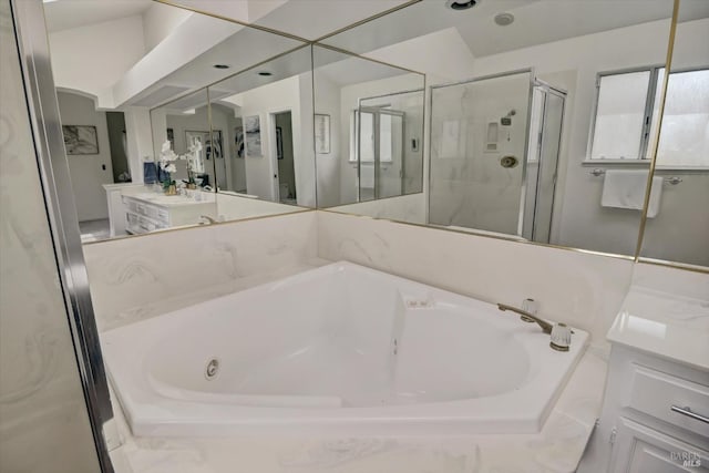 bathroom with vaulted ceiling, shower with separate bathtub, and vanity