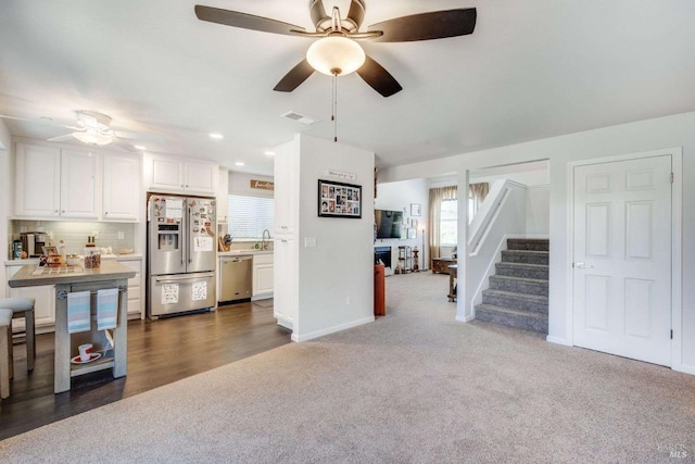 living room with sink, ceiling fan, and dark hardwood / wood-style flooring