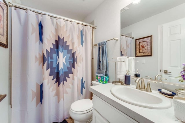 bathroom with vanity, curtained shower, and toilet