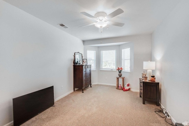 miscellaneous room featuring light colored carpet and ceiling fan