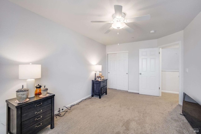 interior space featuring a closet, ceiling fan, and light colored carpet