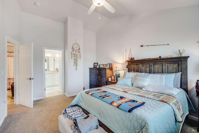 carpeted bedroom with high vaulted ceiling, connected bathroom, and ceiling fan