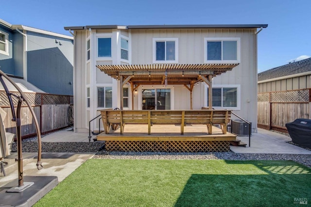 rear view of house featuring a pergola, a deck, a lawn, central AC, and a patio area