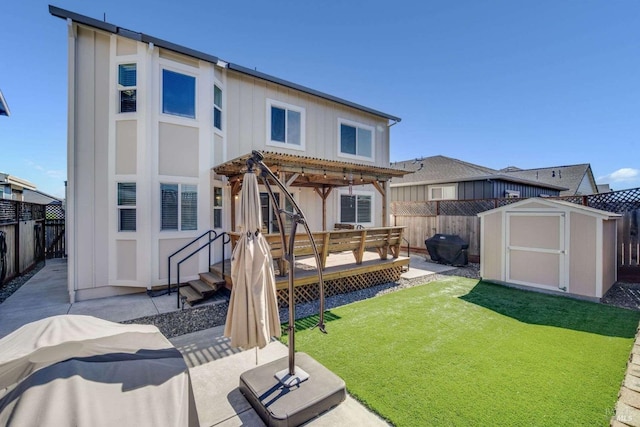 back of property featuring a storage unit, a yard, a patio area, and a pergola