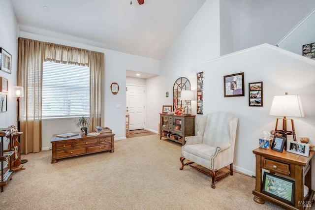 sitting room with light carpet, high vaulted ceiling, and ceiling fan