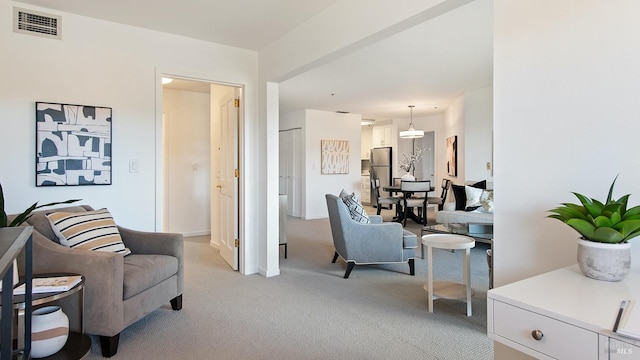 sitting room featuring light colored carpet