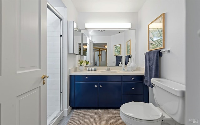 bathroom with vanity, toilet, and an enclosed shower