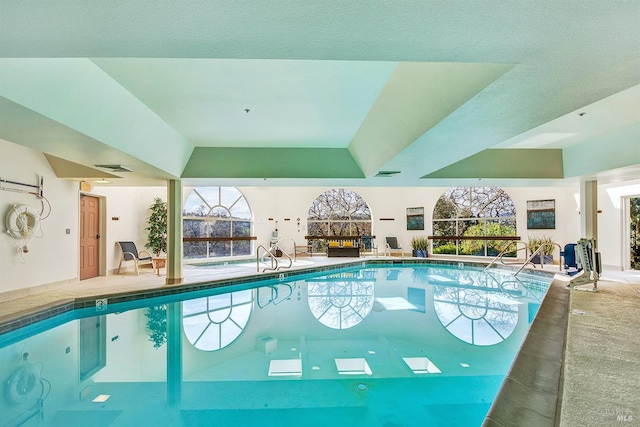 view of swimming pool with a patio and a lanai