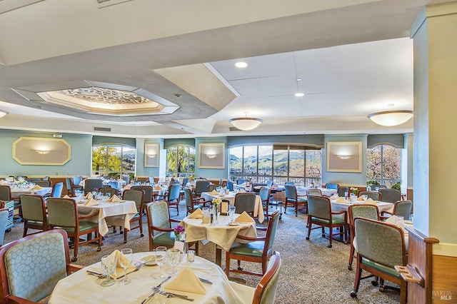 dining area featuring hardwood / wood-style flooring and a tray ceiling