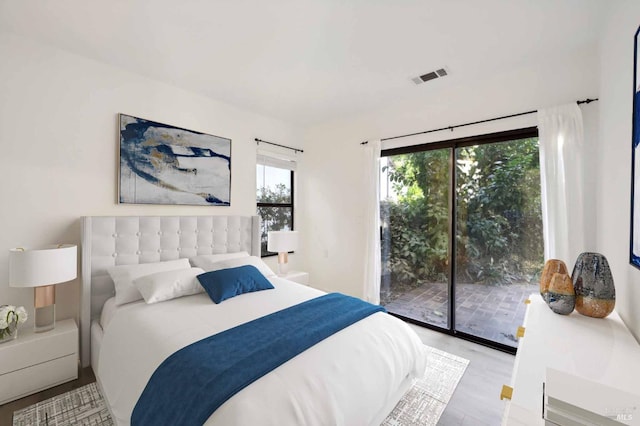 bedroom featuring access to outside and light hardwood / wood-style flooring