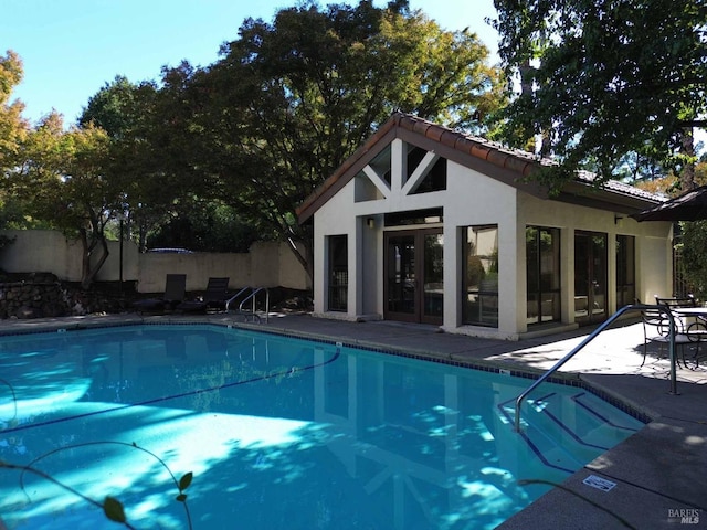 view of swimming pool featuring a patio area and an outdoor structure