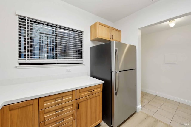 kitchen with stainless steel fridge and light tile patterned flooring