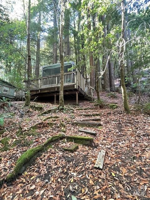 rear view of property featuring a wooden deck