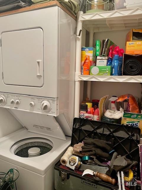 laundry area featuring stacked washer / dryer