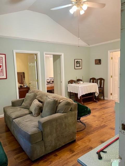 bedroom with hardwood / wood-style floors, lofted ceiling, and ceiling fan