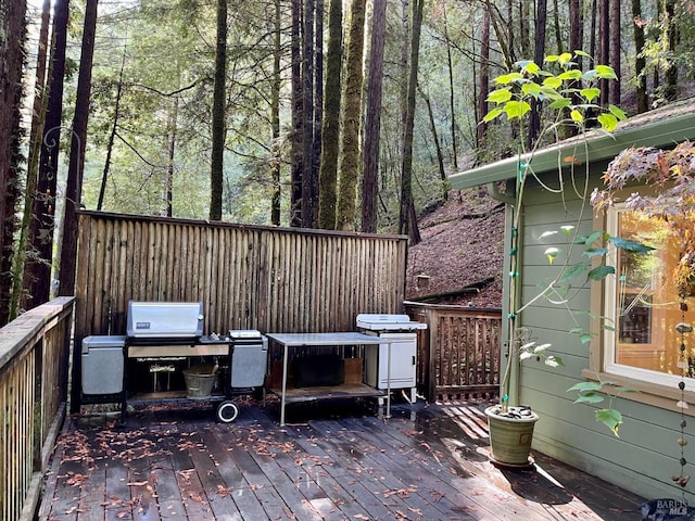 wooden terrace with a grill