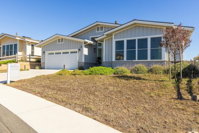 view of front of property with a front yard and a garage