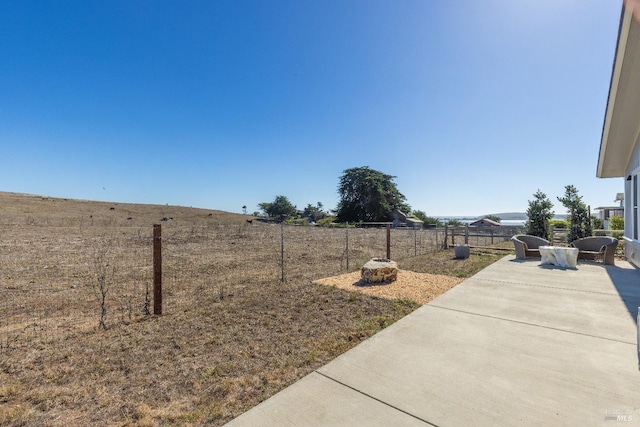 view of yard featuring a rural view and a patio area