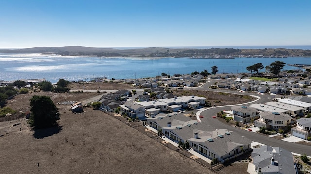 drone / aerial view featuring a water and mountain view