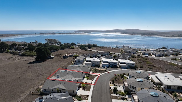 aerial view featuring a water and mountain view