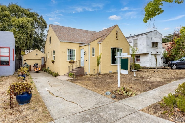 view of front facade featuring an outbuilding and a garage