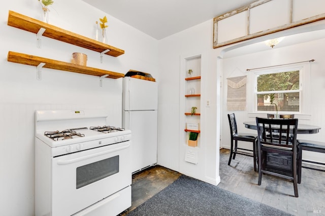 kitchen featuring dark hardwood / wood-style flooring and white appliances