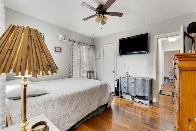 bedroom with ceiling fan and hardwood / wood-style flooring