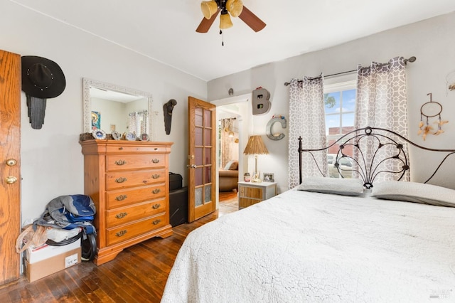 bedroom with dark hardwood / wood-style floors and ceiling fan