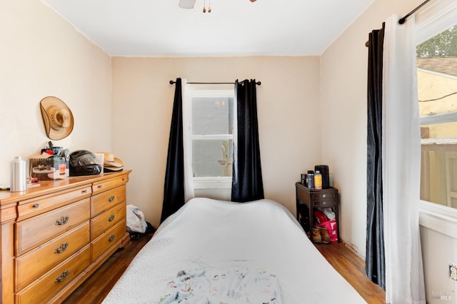 bedroom with ceiling fan and dark wood-type flooring