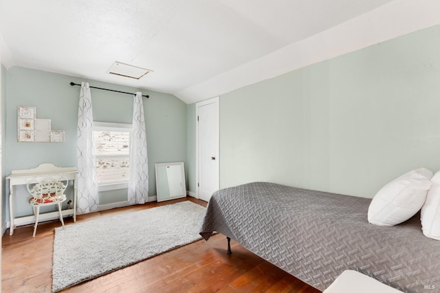 bedroom featuring hardwood / wood-style flooring and vaulted ceiling