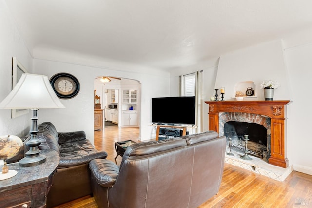 living room with ceiling fan and light hardwood / wood-style floors