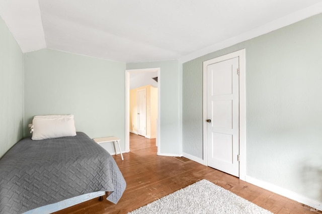 bedroom with hardwood / wood-style floors