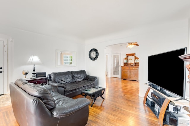 living room featuring ceiling fan and light hardwood / wood-style floors