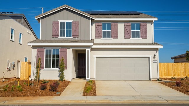 view of front of home featuring a garage and solar panels