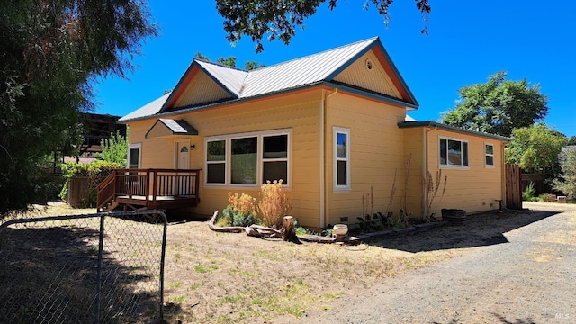 view of property exterior featuring a wooden deck