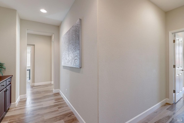 hallway with light hardwood / wood-style flooring