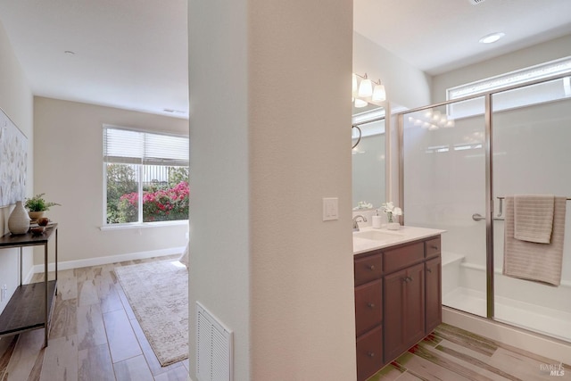 bathroom featuring vanity and a shower with shower door