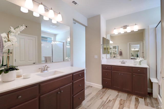 bathroom with hardwood / wood-style floors, vanity, and an enclosed shower