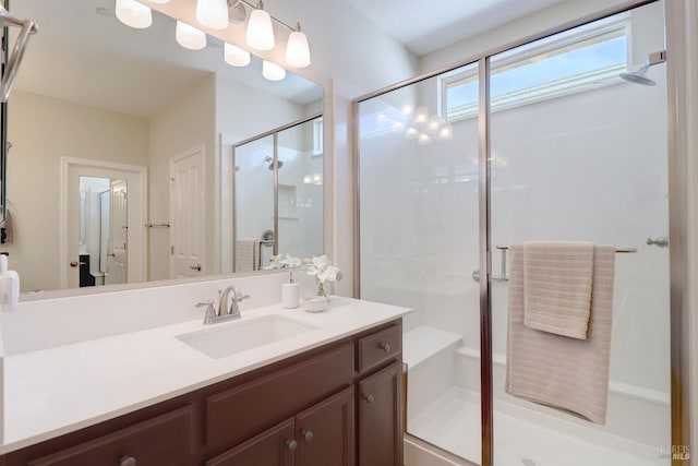 bathroom featuring an enclosed shower and vanity