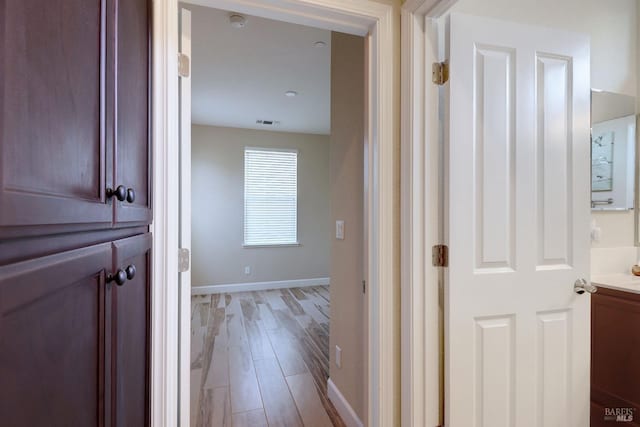 corridor with light wood-type flooring