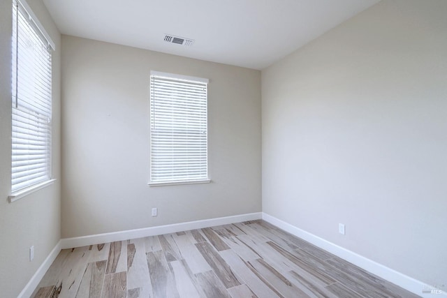 spare room with light wood-type flooring