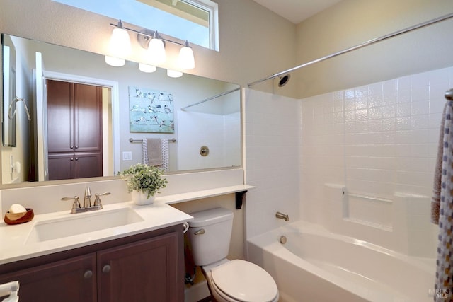 full bathroom featuring vanity, toilet, and  shower combination