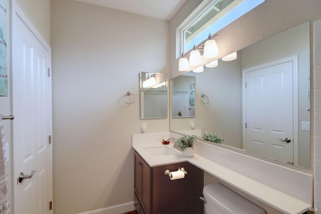 bathroom featuring toilet and vanity