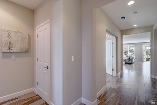 hall with light hardwood / wood-style floors