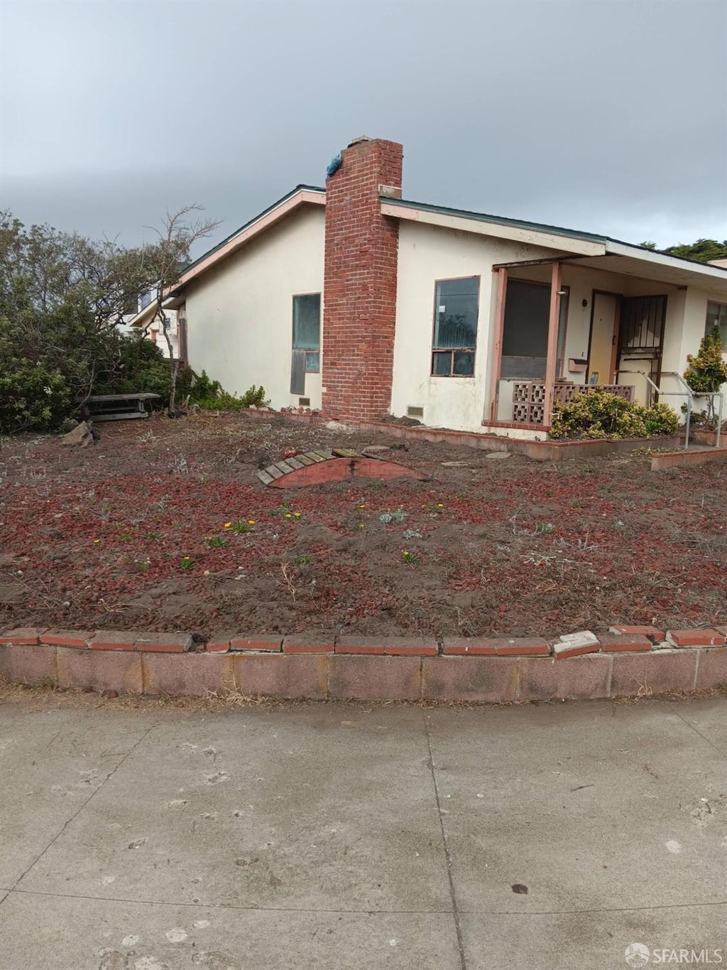 view of side of property with a chimney and stucco siding