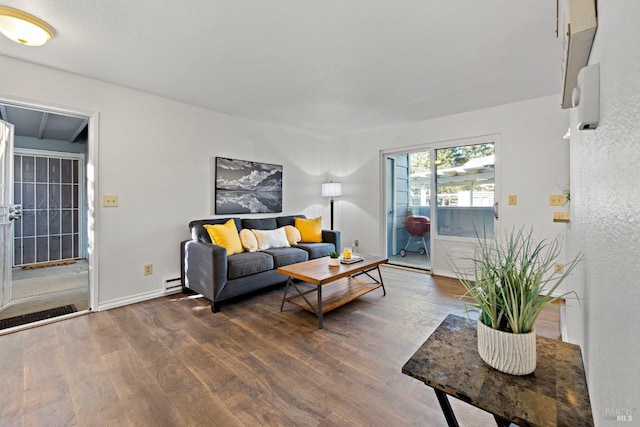 living room featuring dark hardwood / wood-style flooring and a baseboard radiator