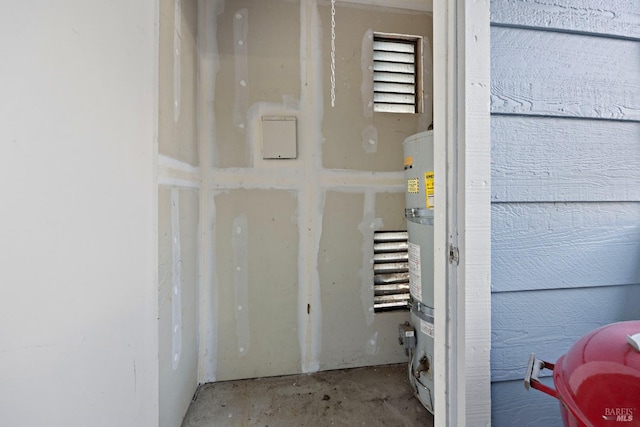 details featuring strapped water heater and concrete floors