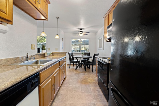 kitchen with ceiling fan, sink, light stone counters, pendant lighting, and black appliances